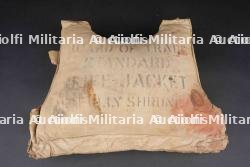 Gilet de sauvetage USN. Part of a US Navy Life Jacket Recovered in Normandy.